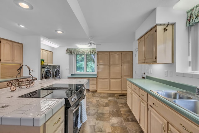 498 Old Dyer Rd, Hayesville, NC 28904 - kitchen with independent washer and dryer, stainless steel electric stove, tile countertops, stone finish flooring, and recessed lighting