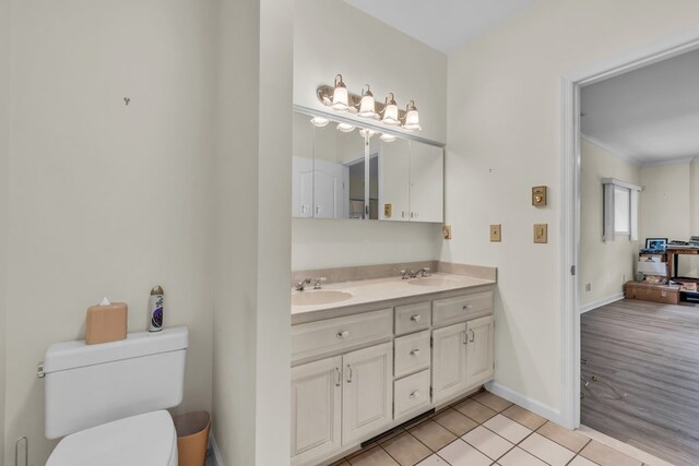 498 Old Dyer Rd, Hayesville, NC 28904 - bathroom with toilet, baseboards, double vanity, ornamental molding, and tile patterned floors