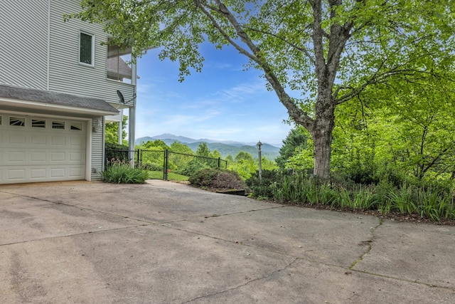 498 Old Dyer Rd, Hayesville, NC 28904 - view of patio / terrace featuring concrete driveway, fence, a mountain view, a balcony, and an attached garage