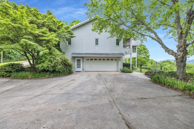 498 Old Dyer Rd, Hayesville, NC 28904 - view of side of property featuring an attached garage, fence, and concrete driveway