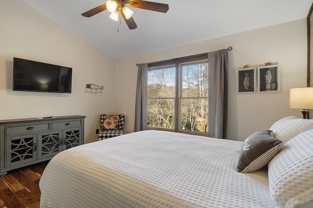 bedroom with lofted ceiling, dark wood finished floors, and ceiling fan