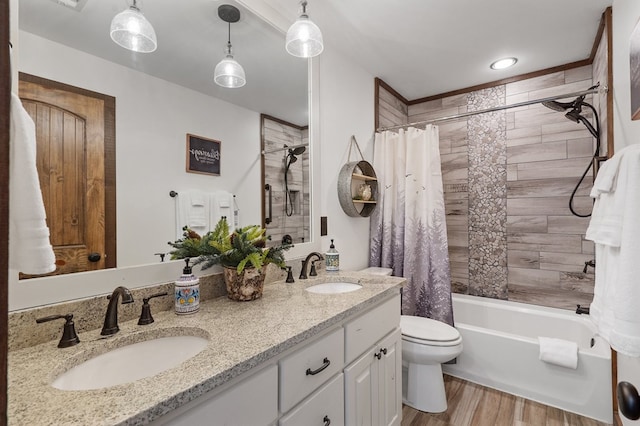 full bathroom featuring toilet, wood finished floors, shower / bath combo, and double vanity