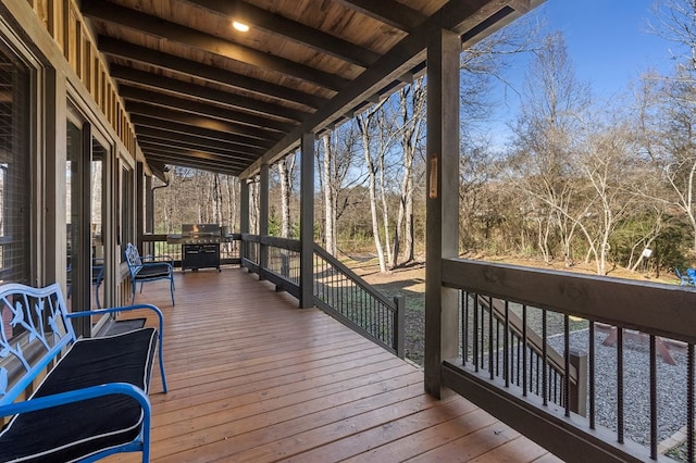 wooden terrace with a grill