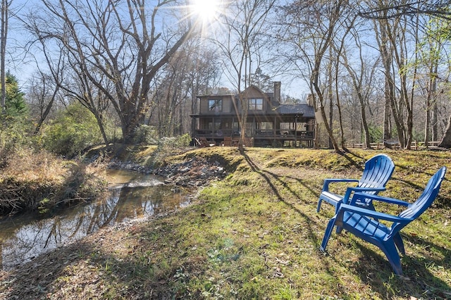 back of property featuring a wooden deck and a chimney