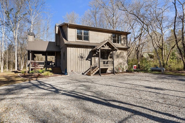 view of front of home with a chimney and metal roof