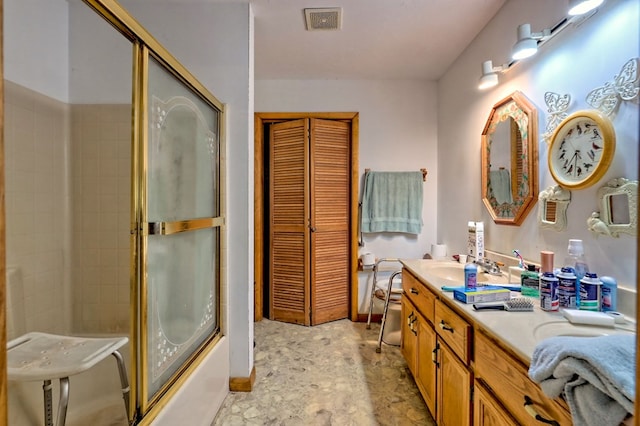 bathroom with vanity and enclosed tub / shower combo