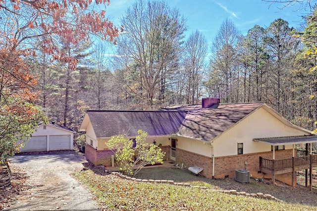 view of home's exterior featuring central AC, an outbuilding, and a garage