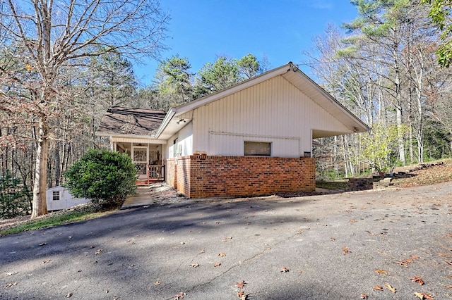 view of home's exterior with a sunroom