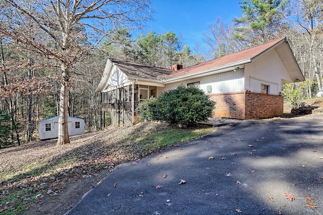 view of property exterior with a storage shed