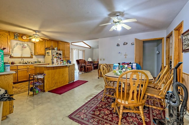 dining room with ceiling fan and sink