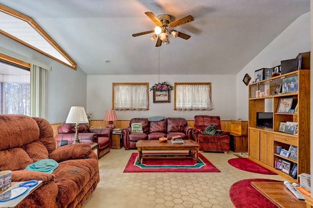 living room featuring ceiling fan and lofted ceiling