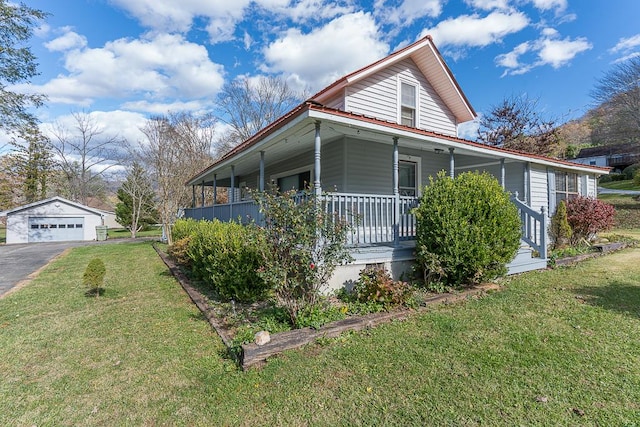 view of front of property featuring a front lawn, covered porch, an outdoor structure, and a garage