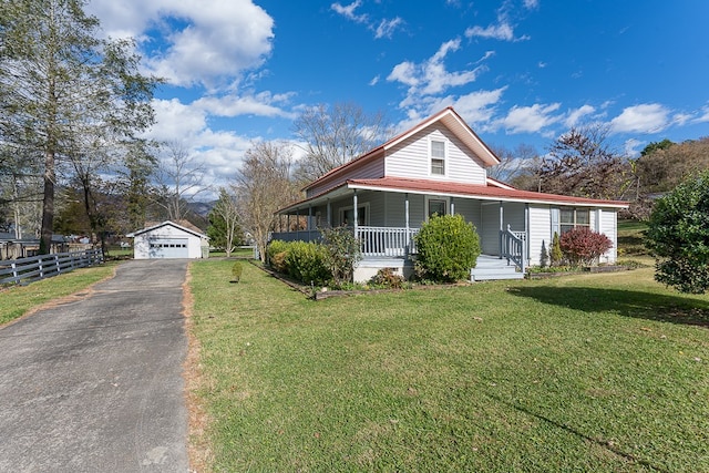 farmhouse featuring a porch, a garage, an outdoor structure, and a front yard