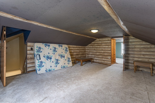 additional living space with carpet flooring, rustic walls, a textured ceiling, and lofted ceiling