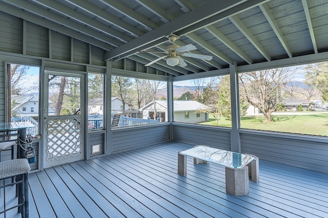 unfurnished sunroom with lofted ceiling with beams and ceiling fan