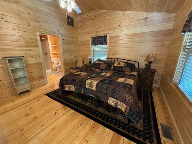 bedroom featuring light wood-type flooring, lofted ceiling, and wood ceiling