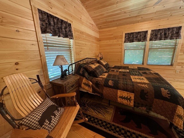 bedroom with hardwood / wood-style flooring, vaulted ceiling, and wooden ceiling