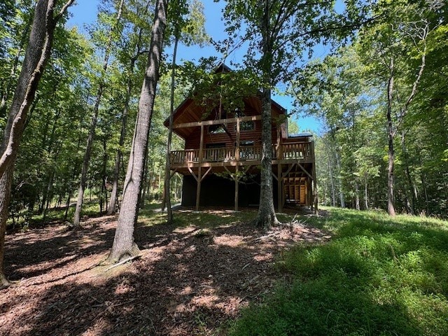 rear view of house featuring a deck