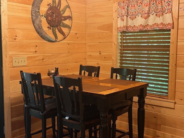 dining room with wood walls