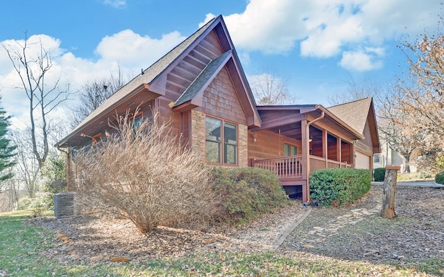 view of property exterior featuring a garage and covered porch