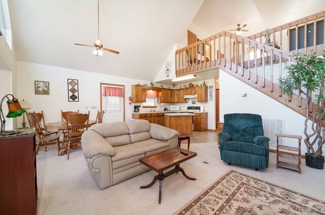 1544 Country Walk, Murphy, NC 28906 - living room featuring stairway, high vaulted ceiling, visible vents, light carpet, and ceiling fan