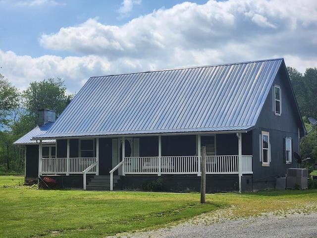 27 Russell Farm Rd, Andrews, NC 28901 - farmhouse inspired home with a porch, metal roof, crawl space, central air condition unit, and a front yard