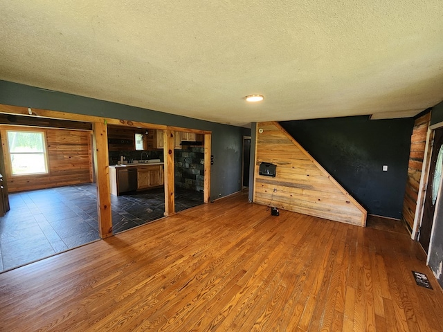 27 Russell Farm Rd, Andrews, NC 28901 - unfurnished living room with wood walls, a textured ceiling, and wood finished floors