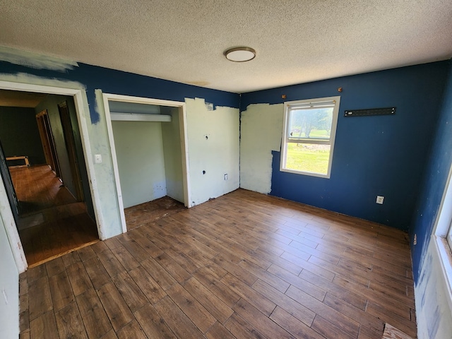 27 Russell Farm Rd, Andrews, NC 28901 - unfurnished bedroom featuring wood finished floors, a textured ceiling, and a closet