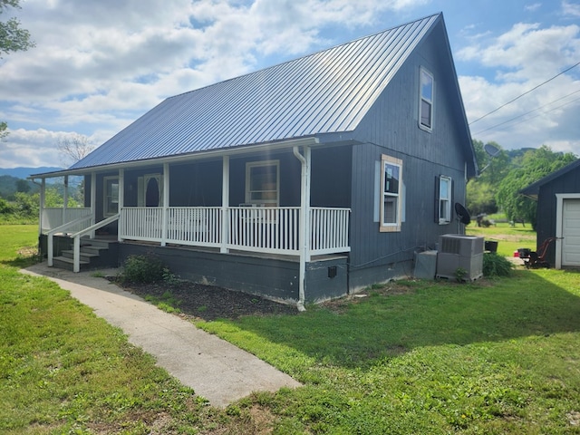 27 Russell Farm Rd, Andrews, NC 28901 - view of side of home with covered porch, a yard, and metal roof