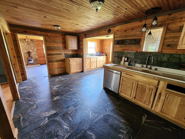 27 Russell Farm Rd, Andrews, NC 28901 - kitchen with dishwasher, wooden walls, a sink, a wood stove, and light brown cabinetry