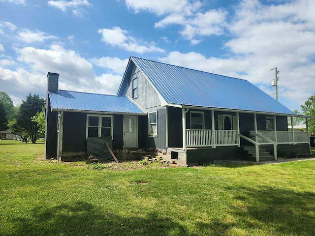 27 Russell Farm Rd, Andrews, NC 28901 - back of property featuring metal roof, covered porch, a chimney, and a yard