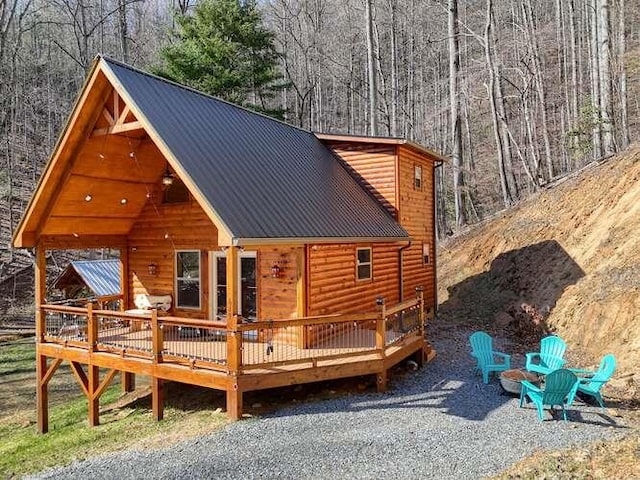 exterior space featuring a fire pit and a wooden deck