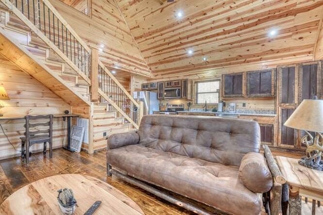 living room with stairs, wooden ceiling, wood finished floors, and high vaulted ceiling