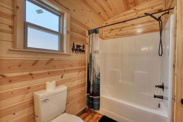 bathroom featuring wooden ceiling, toilet, wood walls, and shower / bath combo