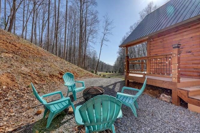 view of yard with a fire pit and a deck