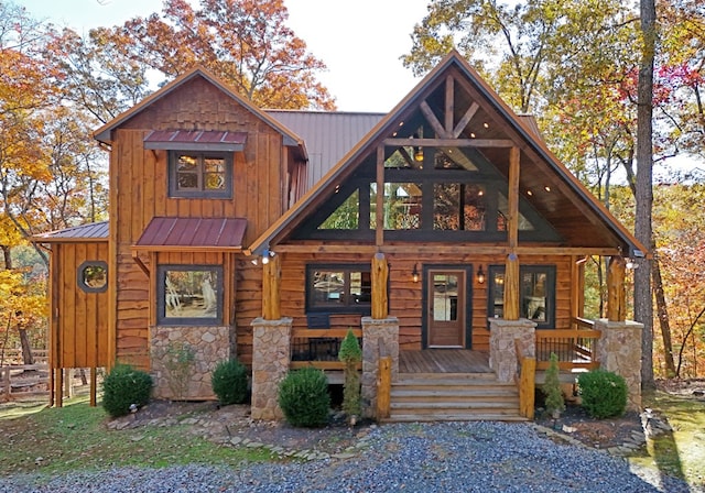 log-style house featuring covered porch