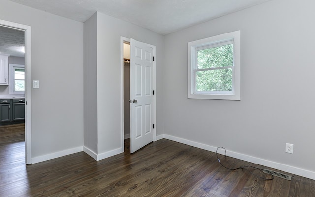 unfurnished bedroom featuring dark wood-type flooring