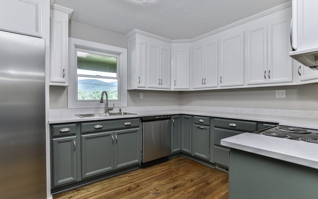 kitchen featuring white cabinets, dark hardwood / wood-style floors, stainless steel appliances, and sink