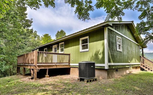 back of house featuring a deck and central AC