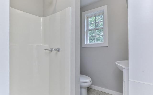 bathroom featuring toilet and tile floors