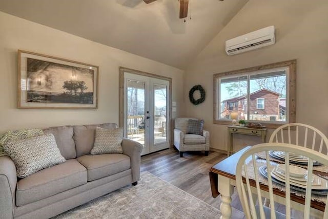 living room featuring hardwood / wood-style flooring, ceiling fan, french doors, vaulted ceiling, and an AC wall unit