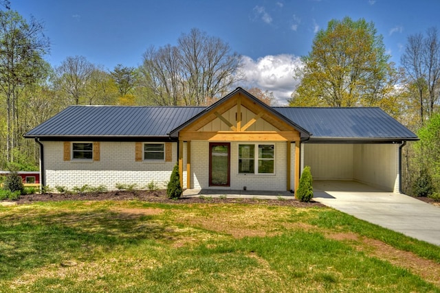 975 Goss Rd, Epworth, GA 30541 - view of front of property with a front yard, brick siding, driveway, an attached carport, and metal roof