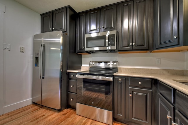 975 Goss Rd, Epworth, GA 30541 - kitchen with appliances with stainless steel finishes, light wood-type flooring, and light countertops