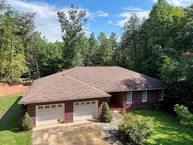 single story home featuring a garage and a front lawn