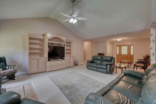 carpeted living room with ceiling fan and vaulted ceiling