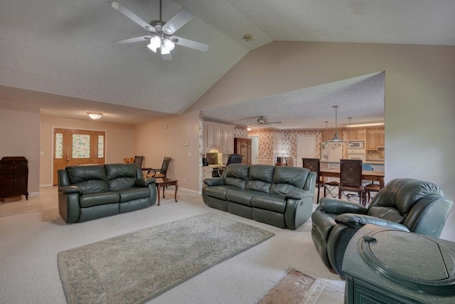 carpeted living room featuring a textured ceiling, ceiling fan, and vaulted ceiling