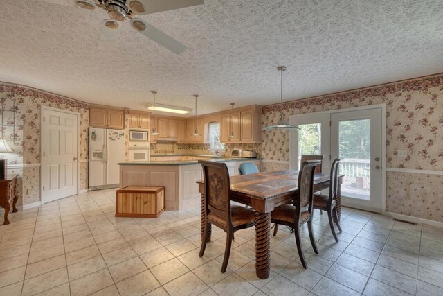 dining room with light tile patterned flooring, a textured ceiling, and ceiling fan