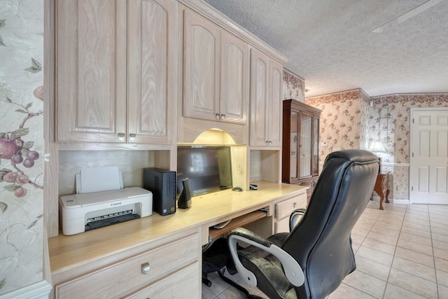 tiled office space with a textured ceiling and built in desk