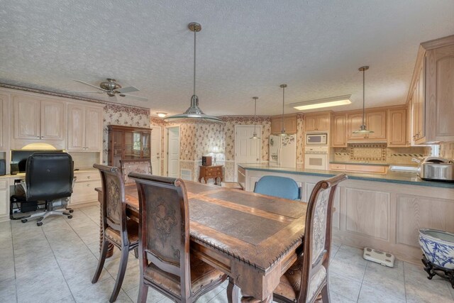 tiled dining room with a textured ceiling and ceiling fan