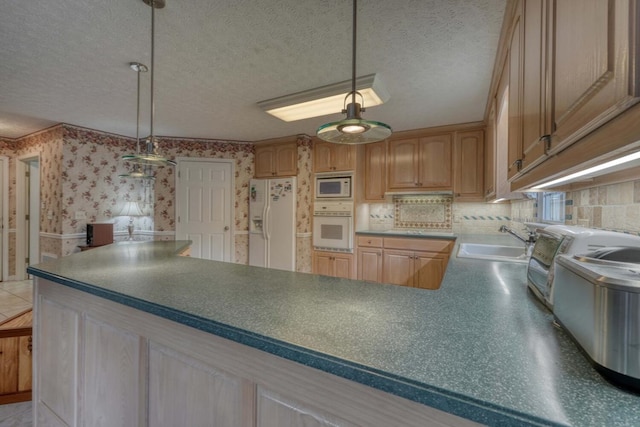 kitchen featuring sink, a textured ceiling, backsplash, and white appliances